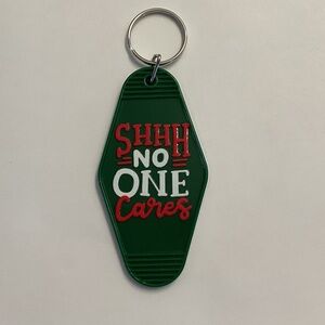 Green Keychain with Red and White Text